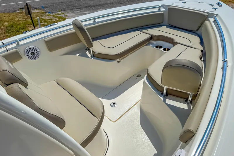 Slide: The Image of 2021 Key West 239 FS boat interior with cushioned seating and cup holders. - 18