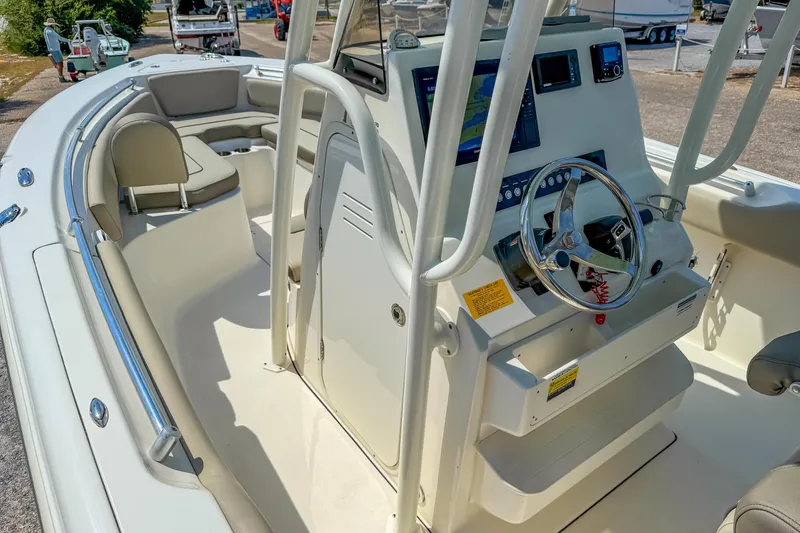 Slide: The Image of 2021 Key West 239 FS boat interior with steering console and seating area. - 20