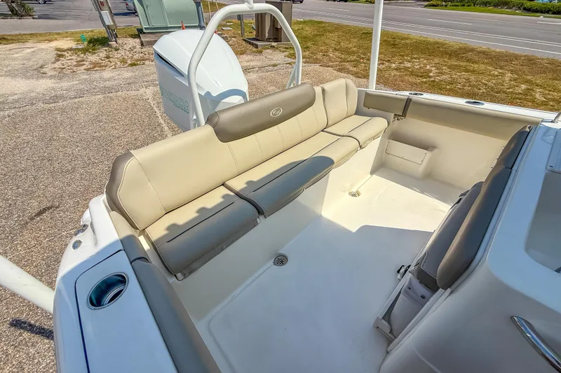 Slide: The Image of 2021 Key West 239 FS boat interior with beige seating and spacious layout. - 21