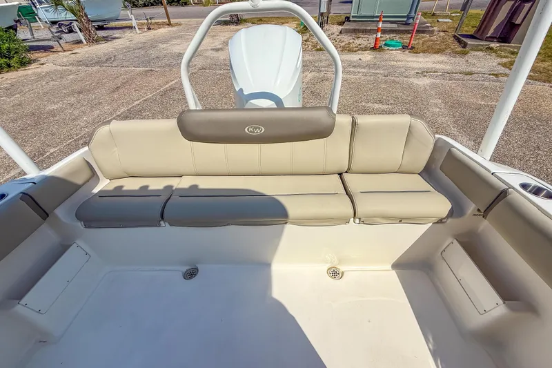 Slide: The Image of 2021 Key West 239 FS boat interior with beige seating and storage compartments. - 22