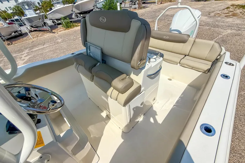 Slide: The Image of 2021 Key West 239 FS boat interior with cushioned seating and steering wheel. - 24
