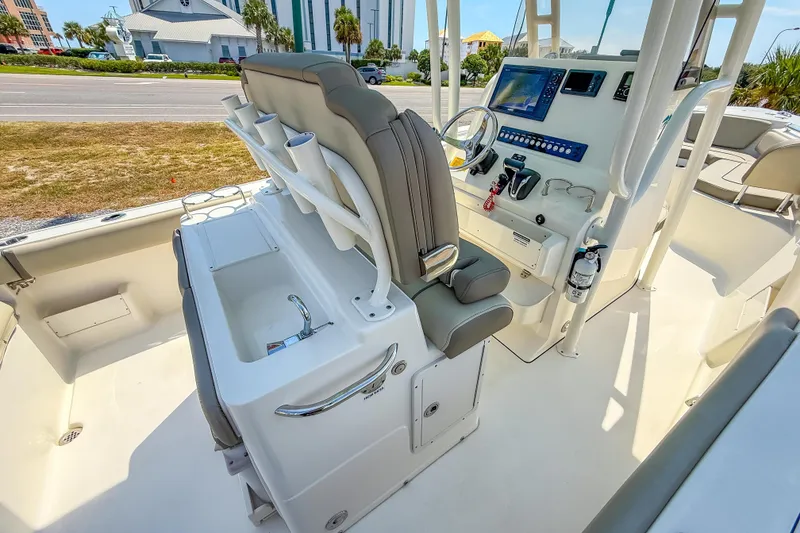 Slide: The Image of 2021 Key West 239 FS boat interior with helm, seating, and control panel. - 26