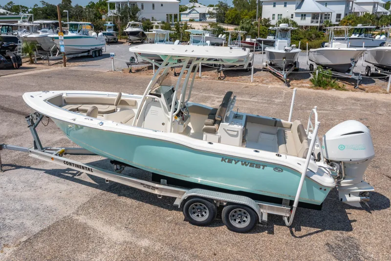 Slide: The Image of 2021 Key West 239 FS boat on trailer, parked in a marina. - 3
