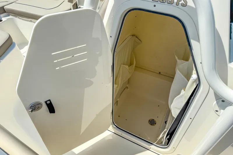 Slide: The Image of 2021 Key West 239 FS boat storage compartment with open door, showcasing interior space. - 31