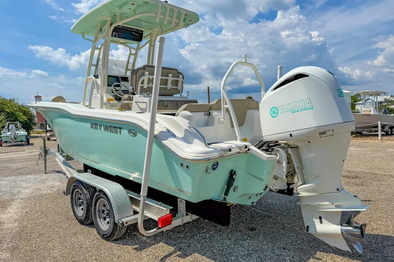 Slide: The Image of 2021 Key West 239 FS boat with Yamaha engine on trailer under blue sky. - 8