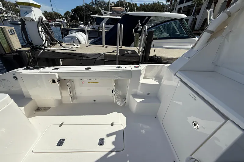 Slide: The Image of 2023 Pursuit OS 355 Offshore boat interior at marina dock, showcasing spacious deck layout. - 19