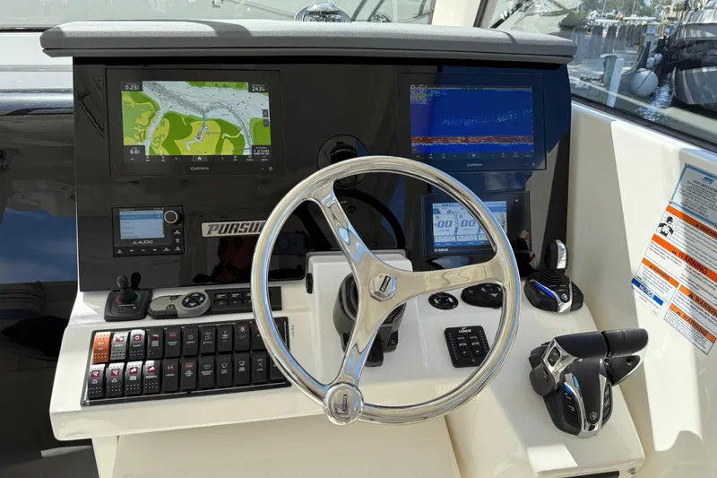 Slide: The Image of 2023 Pursuit OS 355 Offshore helm with advanced navigation and control systems. - 24