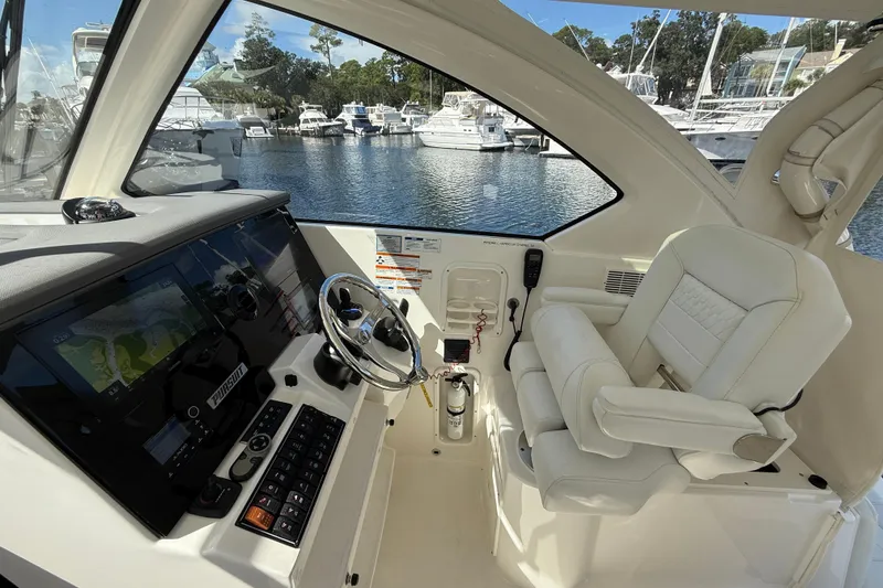 Slide: The Image of 2023 Pursuit OS 355 Offshore helm with modern controls and luxurious seating. - 27