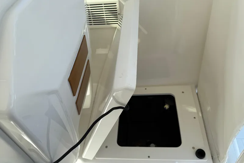 Slide: The Image of 2023 Pursuit OS 355 Offshore boat interior storage compartment with open hatch. - 28