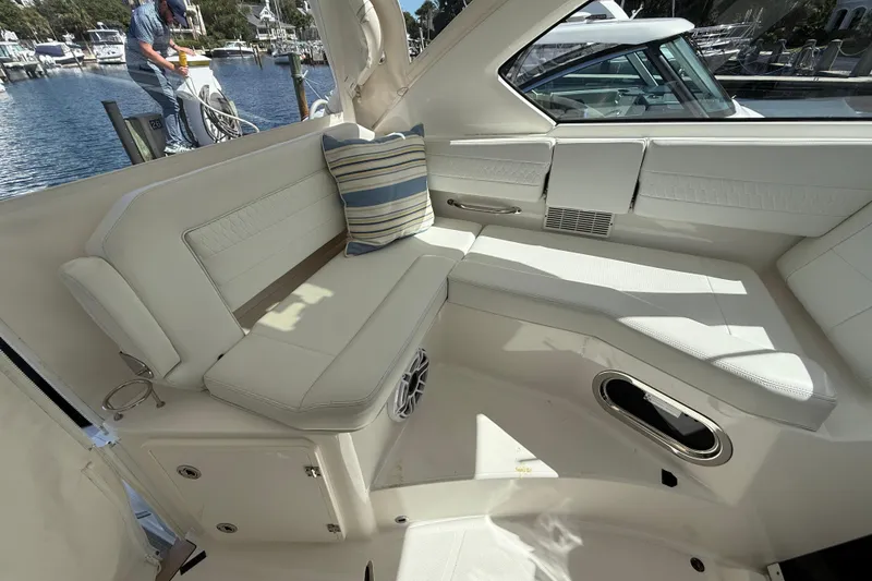 Slide: The Image of 2023 Pursuit OS 355 Offshore boat interior with white seating and striped cushion. - 29