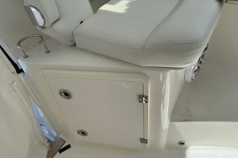 Slide: The Image of 2023 Pursuit OS 355 Offshore boat interior with white seating and storage compartment. - 31