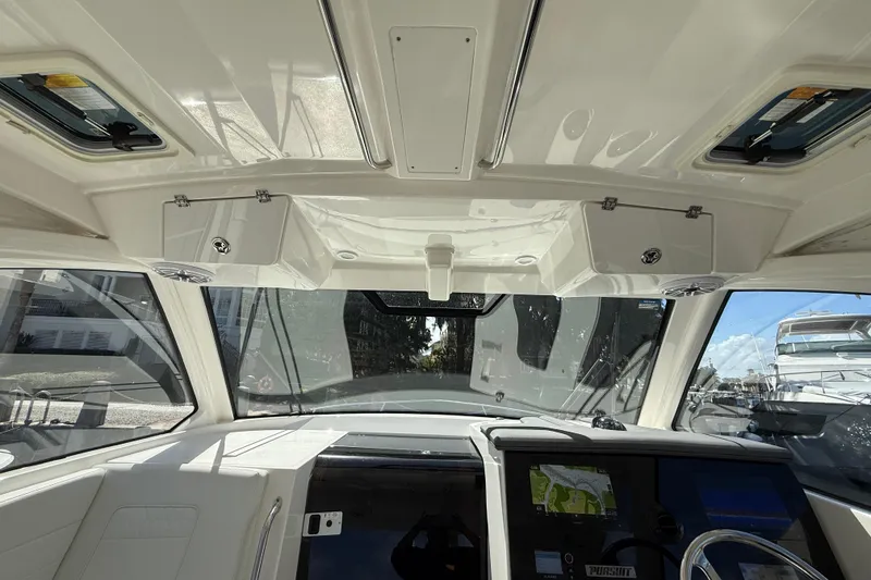Slide: The Image of Interior view of 2023 Pursuit OS 355 Offshore boat cockpit with navigation system. - 34