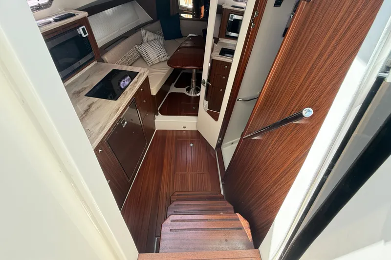 Slide: The Image of 2023 Pursuit OS 355 Offshore cabin interior with wood finish and modern amenities. - 36