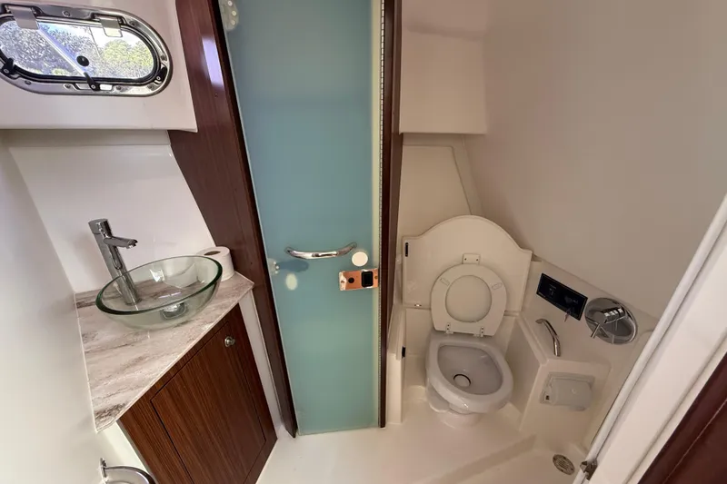 Slide: The Image of 2023 Pursuit OS 355 Offshore boat bathroom with glass sink and modern fixtures. - 39