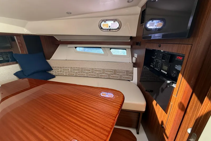 Slide: The Image of Luxurious interior of 2023 Pursuit OS 355 Offshore boat with wood finish and seating area. - 41