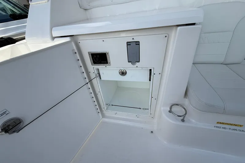Slide: The Image of 2023 Pursuit OS 355 Offshore boat interior storage compartment with emergency equipment. - 51
