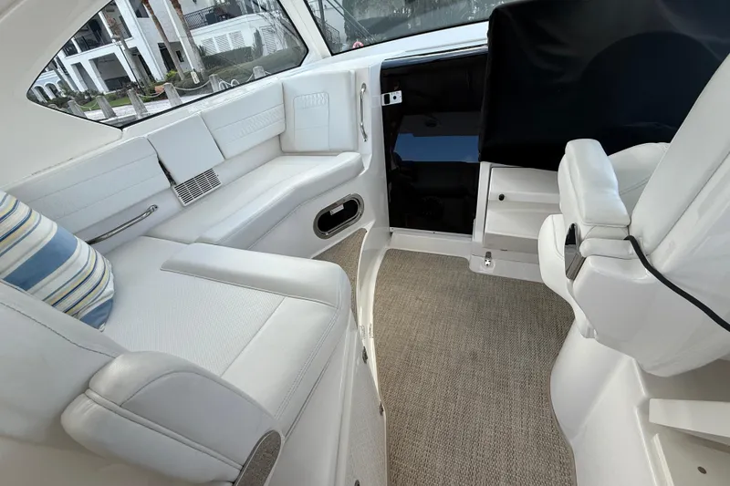 Slide: The Image of Luxurious interior of 2023 Pursuit OS 355 Offshore boat with white seating and striped pillow. - 53