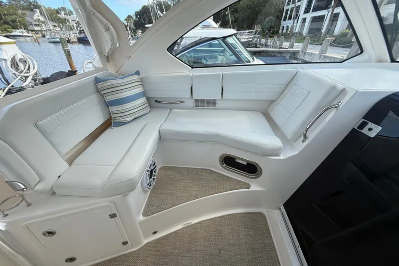 Slide: The Image of 2023 Pursuit OS 355 Offshore boat interior with white seating and striped cushion. - 54