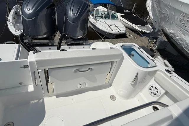 Slide: The Image of 2025 Wellcraft 243 Fisherman boat deck with dual engines and storage compartments. - 11