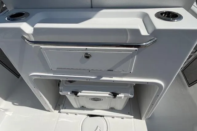 Slide: The Image of 2025 Wellcraft 243 Fisherman boat console with storage and cup holders. - 12