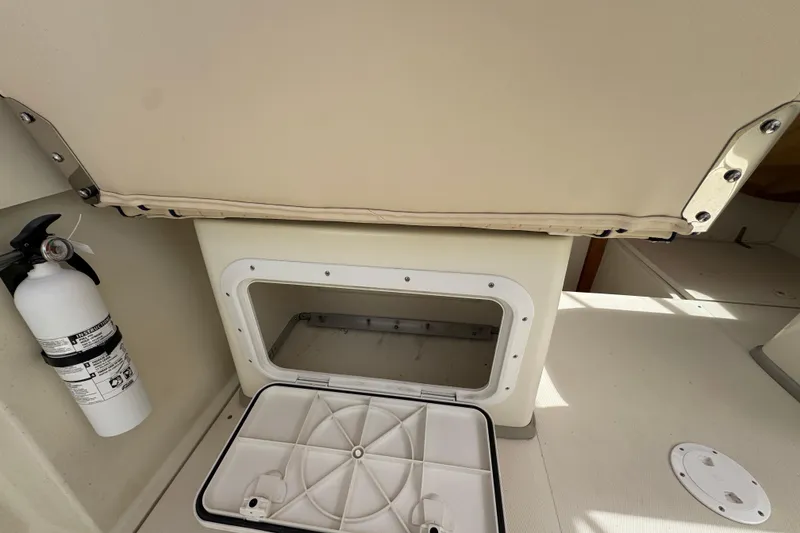 Slide: The Image of 2006 Limestone 26 boat interior with storage compartment and fire extinguisher. - 14