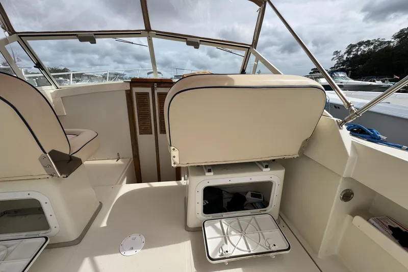Slide: The Image of 2006 Limestone 26 boat interior with seating and storage compartments. - 16