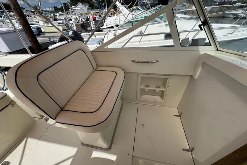 Slide: The Image of Interior of a 2006 Limestone 26 boat with cushioned seating and cup holders. - 17