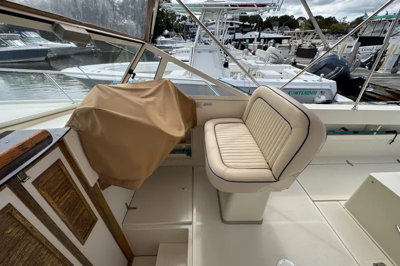 Slide: The Image of 2006 Limestone 26 boat interior with cushioned seating at marina. - 20