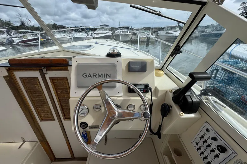 Slide: The Image of Helm of 2006 Limestone 26 boat with Garmin navigation system, docked at marina. - 22