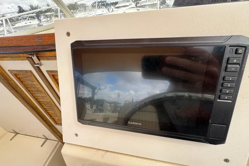 Slide: The Image of Garmin navigation system on 2006 Limestone 26 boat dashboard. - 23