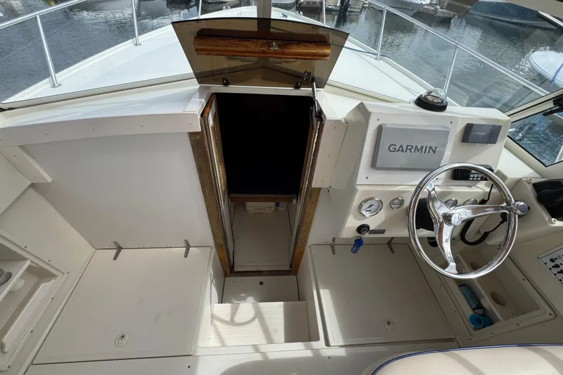 Slide: The Image of 2006 Limestone 26 boat cockpit with Garmin navigation, steering wheel, and cabin entrance. - 26