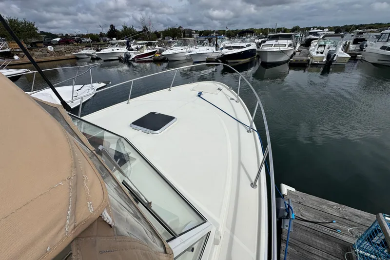 Slide: The Image of 2006 Limestone 26 boat docked at a marina with other vessels. - 32
