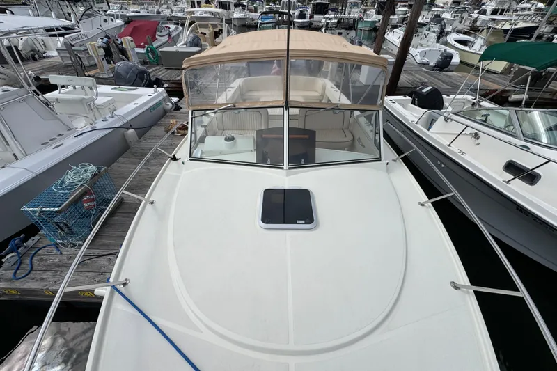 Slide: The Image of 2006 Limestone 26 boat docked at marina, surrounded by other vessels. - 35