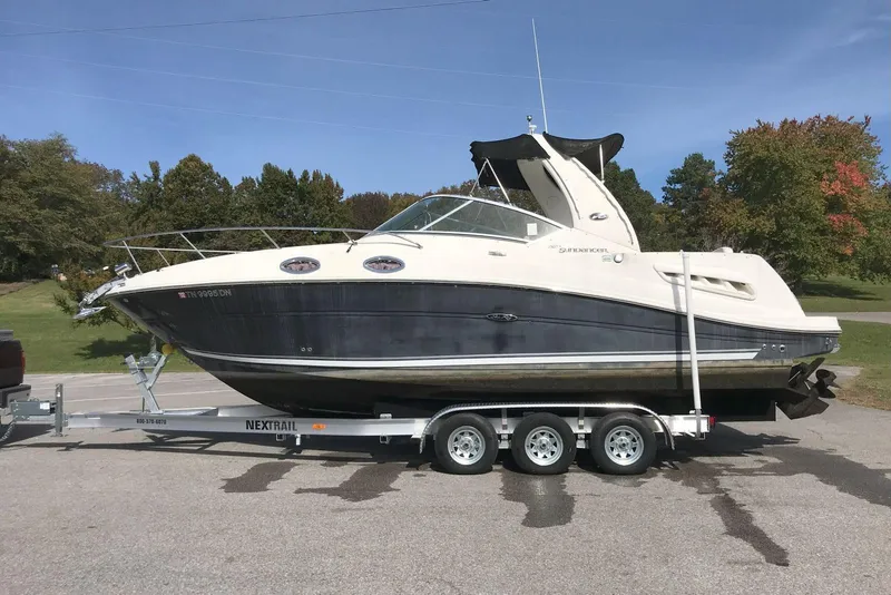 Slide: The Image of 2006 Sea Ray 260 Sundancer boat on trailer, parked outdoors on a sunny day. - 1