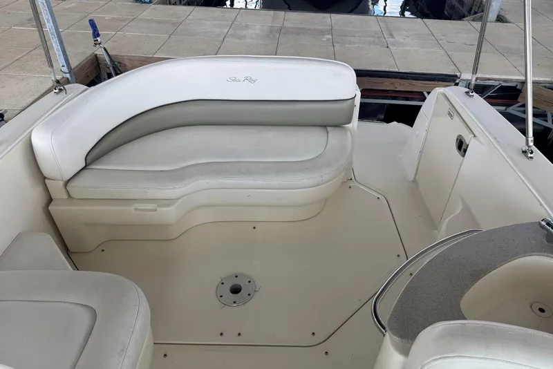 Slide: The Image of 2006 Sea Ray 260 Sundancer boat interior with white seating and deck area. - 10