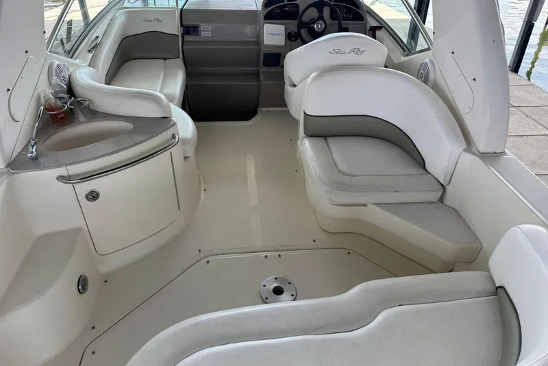 Slide: The Image of 2006 Sea Ray 260 Sundancer boat interior with seating and helm. - 11