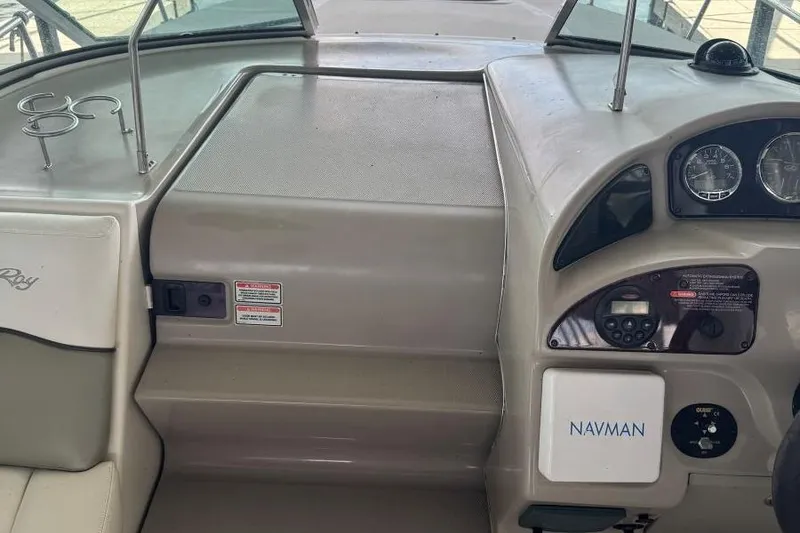 Slide: The Image of 2006 Sea Ray 260 Sundancer dashboard with Navman system and cup holders. - 12