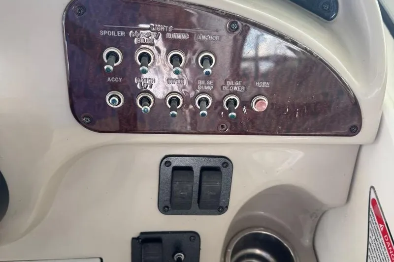 Slide: The Image of Control panel of a 2006 Sea Ray 260 Sundancer boat with switches and labels. - 14