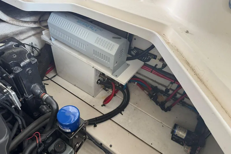 Slide: The Image of Engine compartment of a 2006 Sea Ray 260 Sundancer boat, showing mechanical components. - 17