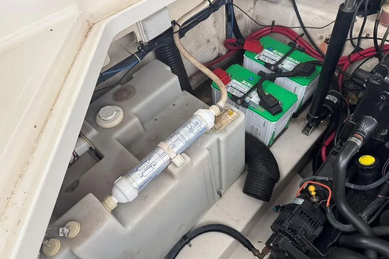Slide: The Image of Engine compartment of 2006 Sea Ray 260 Sundancer with batteries and fuel filter visible. - 18