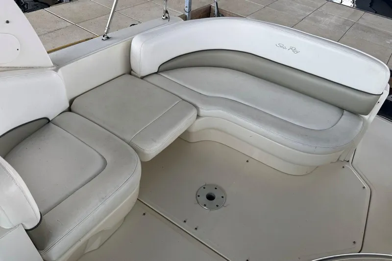 Slide: The Image of 2006 Sea Ray 260 Sundancer boat seating area with white and gray upholstery. - 21