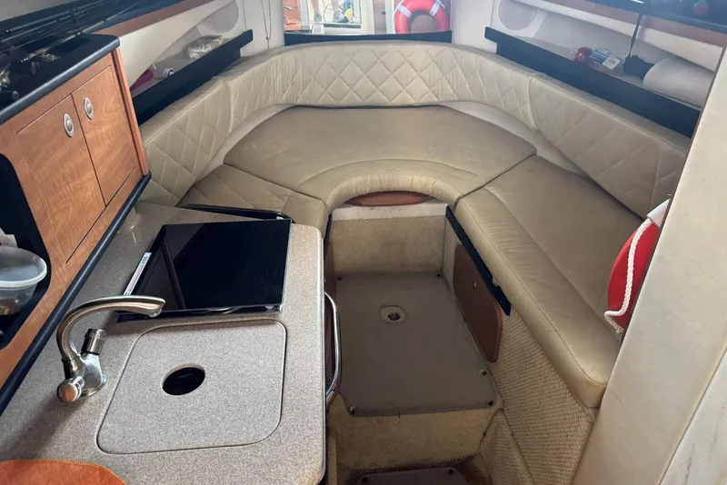 Slide: The Image of Interior of 2006 Sea Ray 260 Sundancer with kitchenette and seating area. - 22