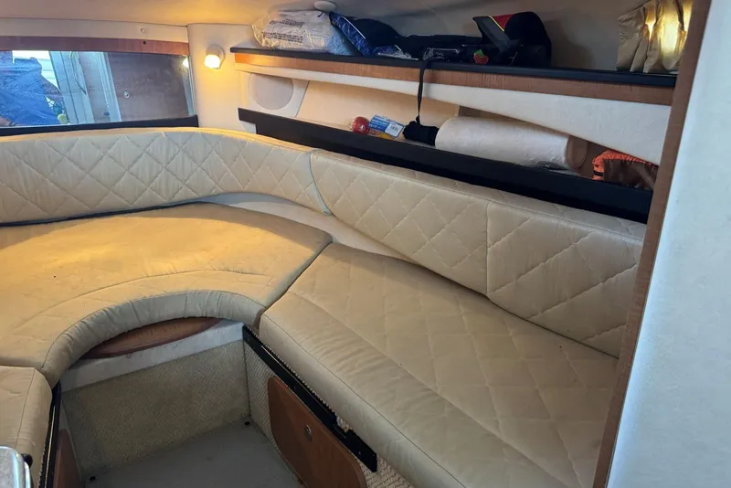 Slide: The Image of Interior cabin of 2006 Sea Ray 260 Sundancer with beige quilted seating. - 24