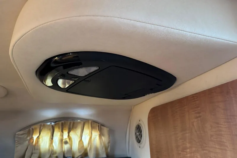 Slide: The Image of Ceiling speaker in 2006 Sea Ray 260 Sundancer cabin, featuring beige interior and wood paneling. - 26