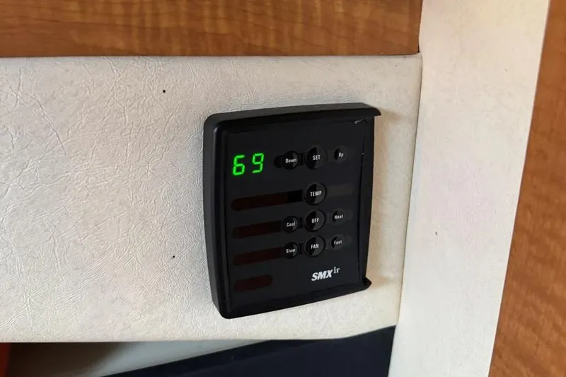 Slide: The Image of Thermostat control panel on 2006 Sea Ray 260 Sundancer boat, displaying temperature setting. - 27