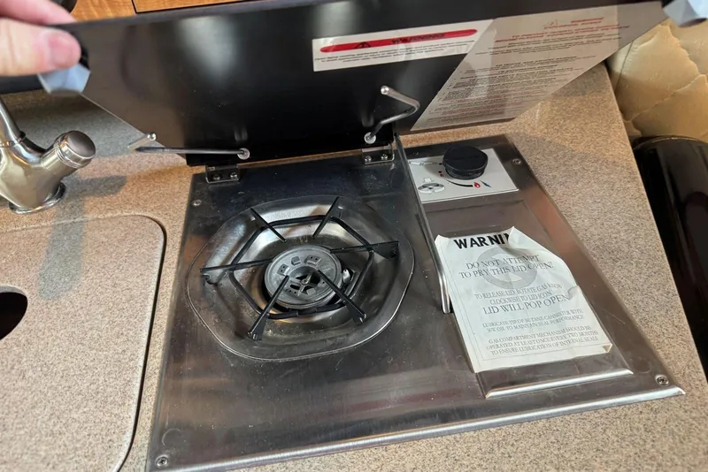 Slide: The Image of Stove in 2006 Sea Ray 260 Sundancer boat galley with safety warning label. - 29