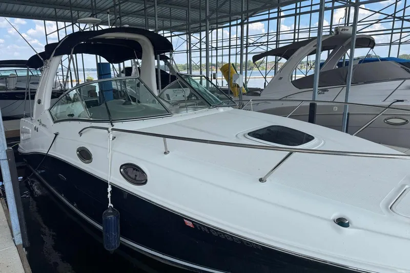 Slide: The Image of 2006 Sea Ray 260 Sundancer docked in a marina under a covered structure. - 3