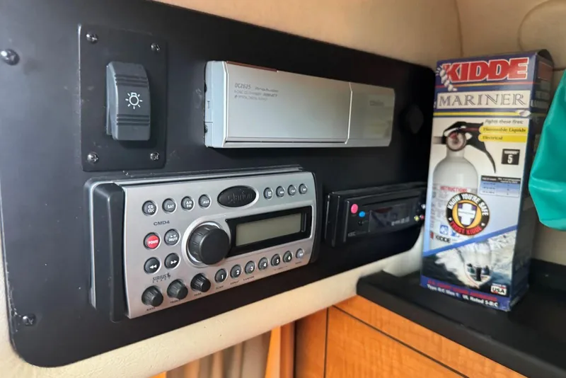 Slide: The Image of Control panel of a 2006 Sea Ray 260 Sundancer with stereo and fire extinguisher. - 32