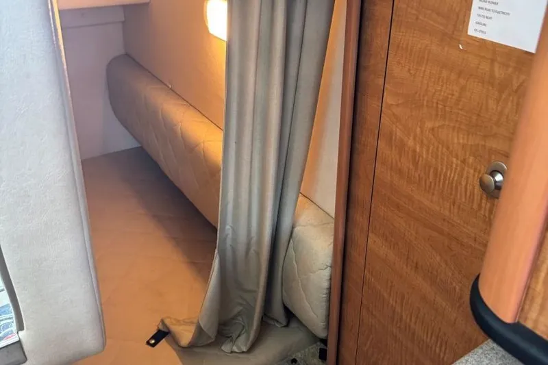 Slide: The Image of Interior cabin of 2006 Sea Ray 260 Sundancer with cozy seating and wooden accents. - 33