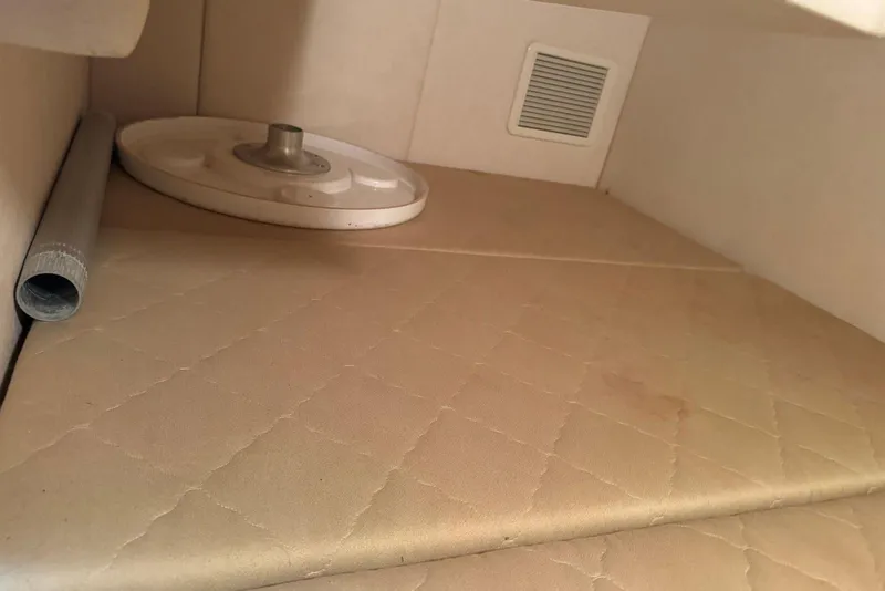 Slide: The Image of 2006 Sea Ray 260 Sundancer cabin interior with beige upholstery and vent. - 34